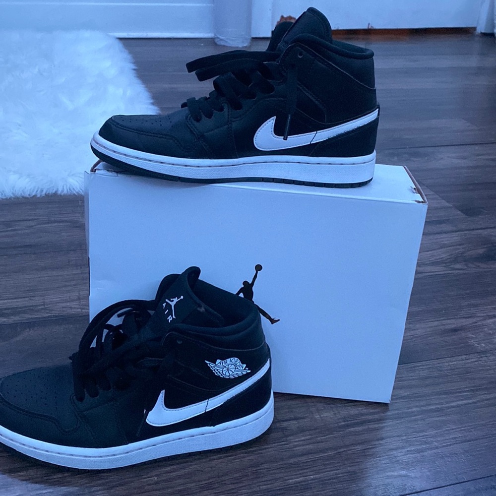 Black and white mid Jordan 1s